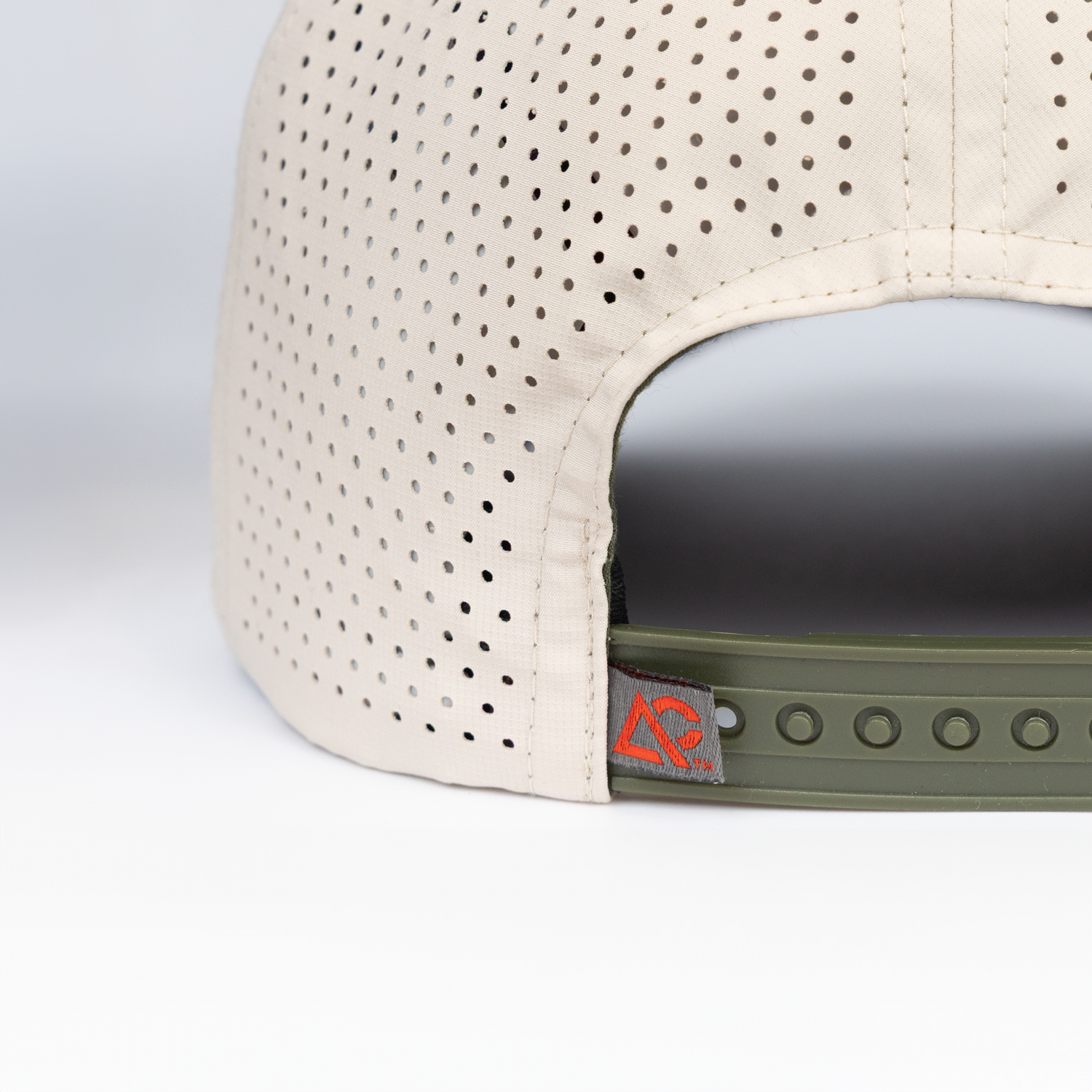 closeup of adjustable strap on natural hat showing "AC" Archery Country label