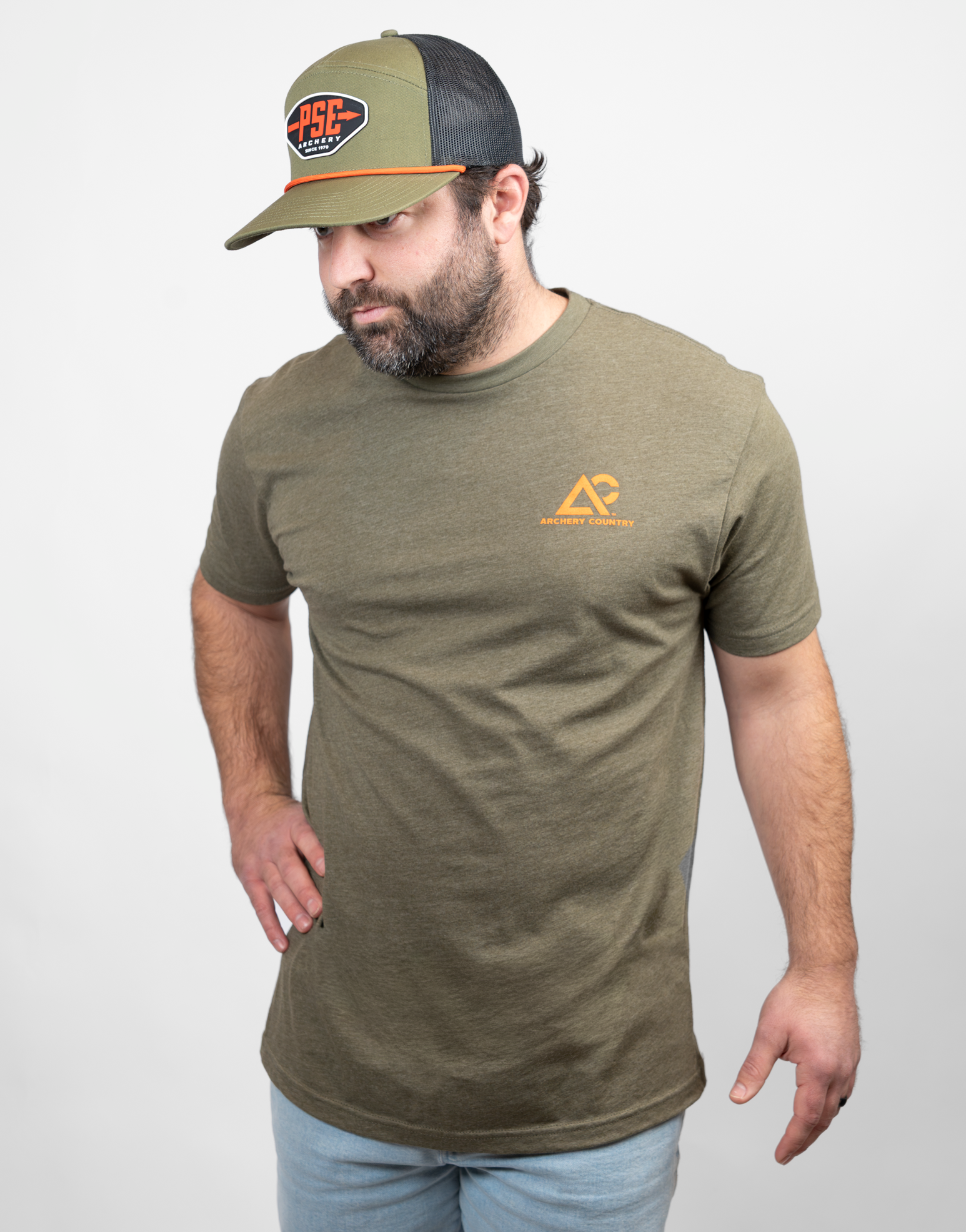 Man wearing military green tee with small Archery Country logo on left chest