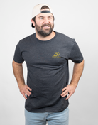 Man wearing charcoal tee with small Archery Country logo on left chest