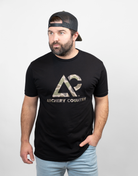 Man wearing black tee with camo "ARCHERY COUNTRY" logo on chest