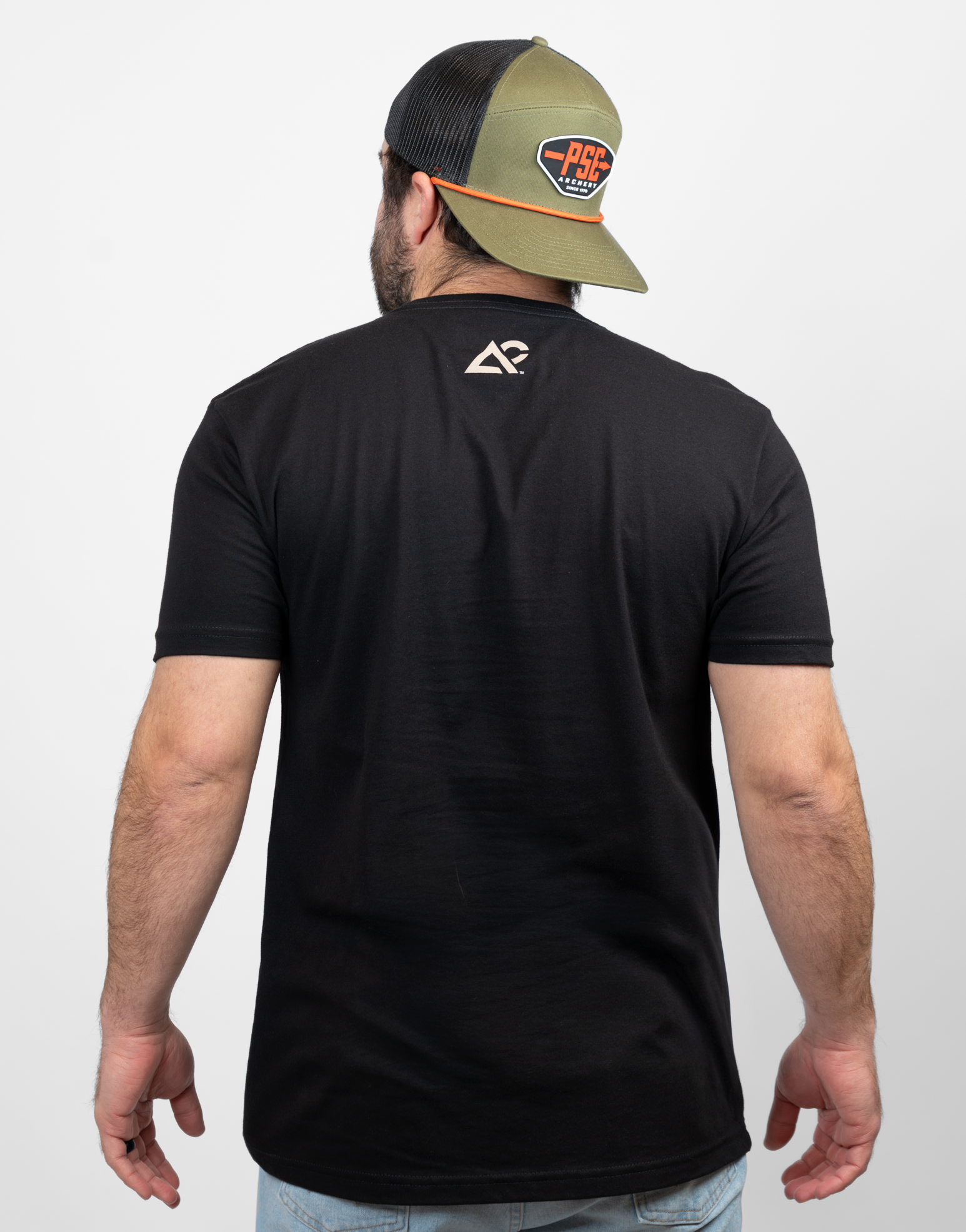 rear view of man in black tee with small Archery Country logo on upper back