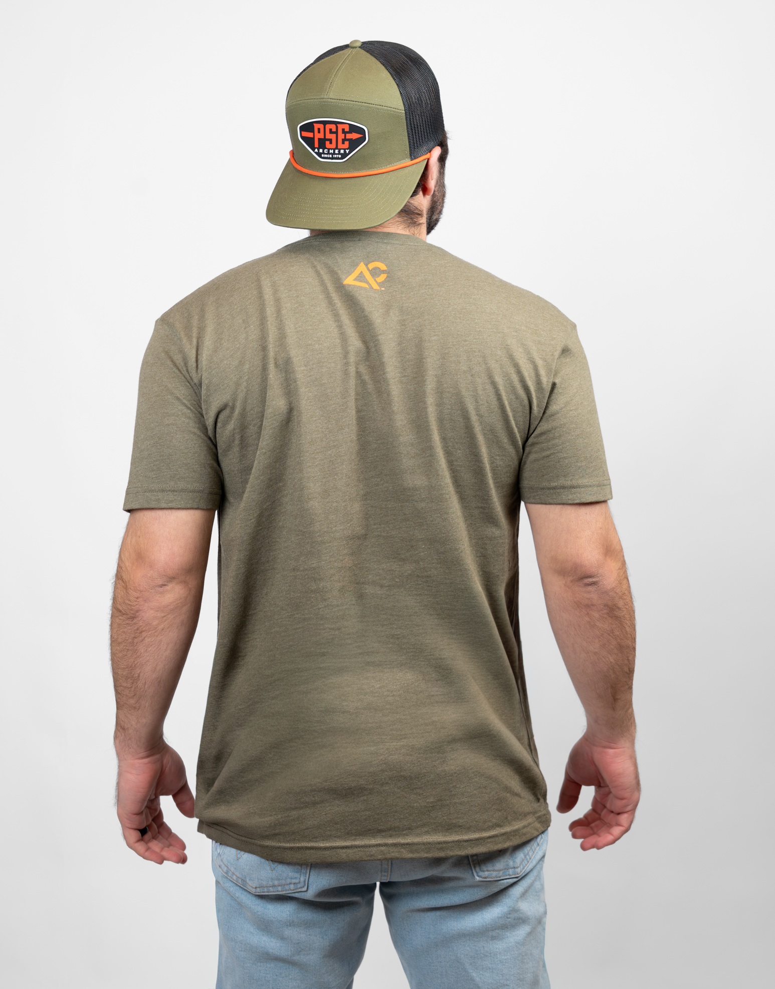 rear view of man in military green tee with small Archery Country logo on upper back