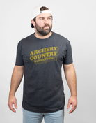 Man wearing charcoal tee with text "ARCHERY COUNTRY Austin, Texas"