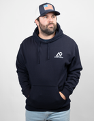 Man wearing navy hoodie with white Archery Country logo on left chest