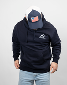 man wearing navy hoodie with white Archery Country logo on left chest