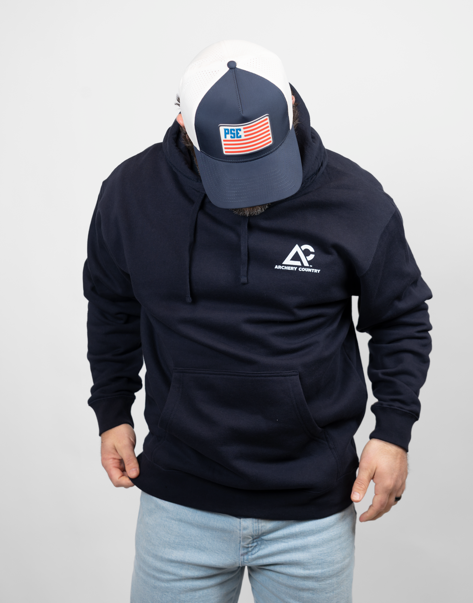 man wearing navy hoodie with white Archery Country logo on left chest
