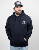 man wearing navy hoodie with white Archery Country logo on left chest
