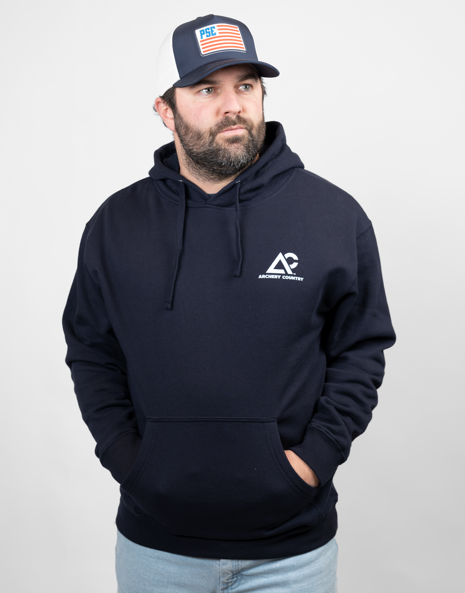 man wearing navy hoodie with white Archery Country logo on left chest