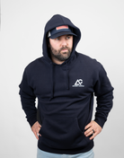 man wearing navy hoodie with hood up with white Archery Country logo on left chest