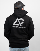man wearing black hoodie with large Archery Country logo on back